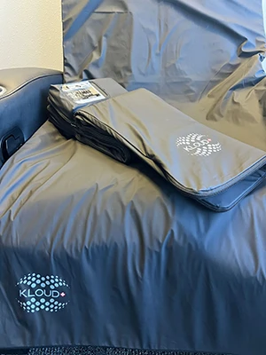 A KLOUD mat sitting atop a chair in a treatment room at Health & Wellness Chiropractic Center